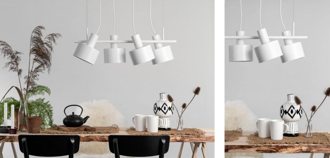 Biała lampa sufitowa z czterema kloszami wisząca nad stołem